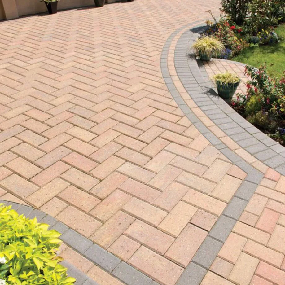 Autumn-gold interlocking pavers in a herringbone pattern