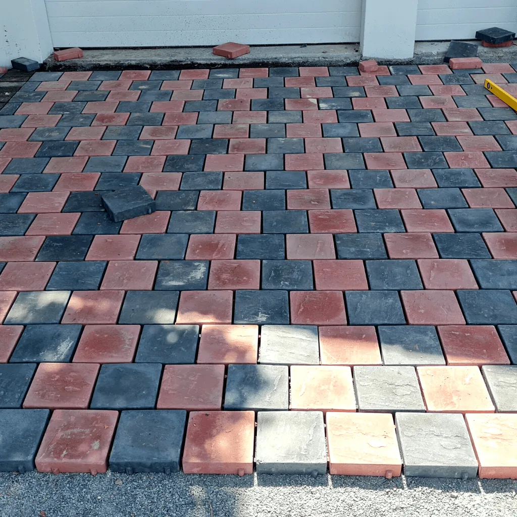 Charcoal and terracotta interlocking cobble pavers laid in a driveway