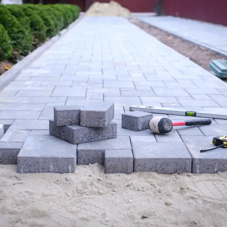 Industrial Paving Projects in Gauteng Paver laying heavy-duty 80mm blocks on a prepared base at an industrial yard in Gauteng