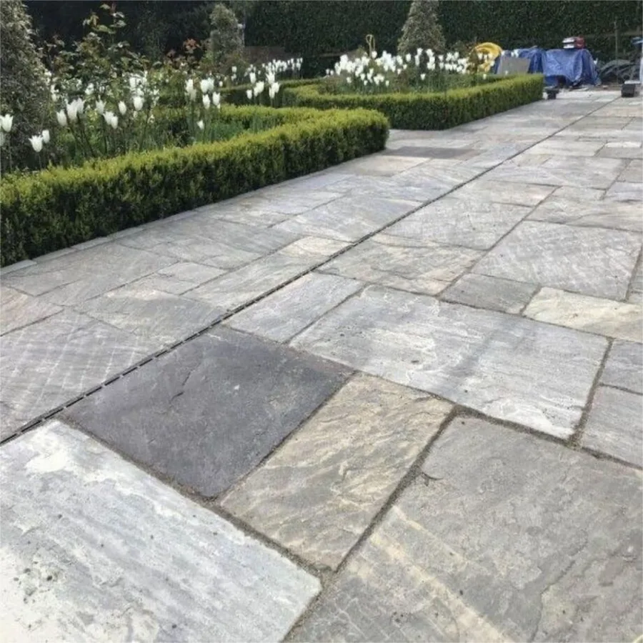 Paving repairs & maintenance in Gauteng Worker relaying grey pavers during a paving repair