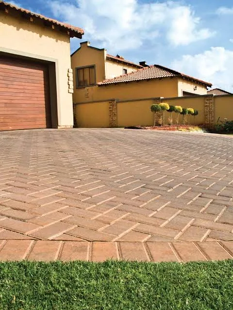 Terracotta brick paving alongside a double garage at a Johannesburg home