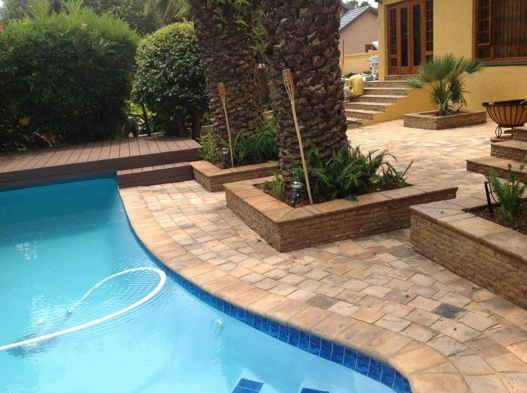 Residential pool deck and patio paving at a landscaped Johannesburg home