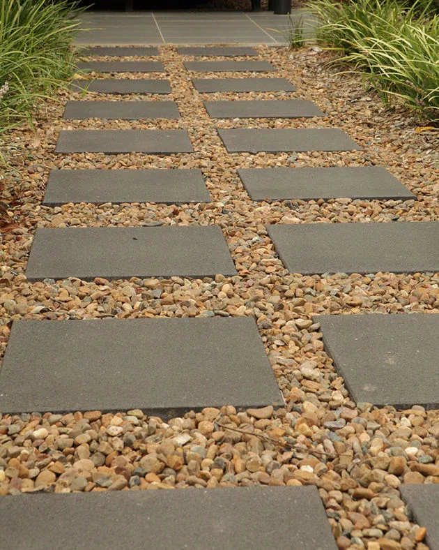 Grey large-format pavers forming a pedestrian walkway at a retail centre